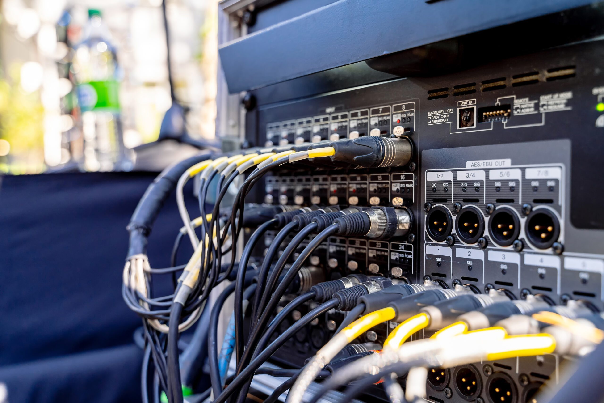 Audio cables connected to sound equipment outdoors.