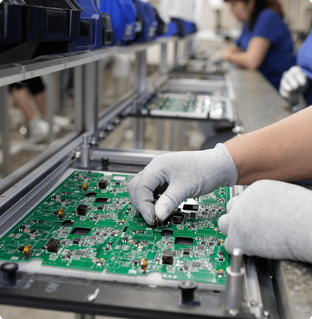 Worker assembling electronic circuit boards.