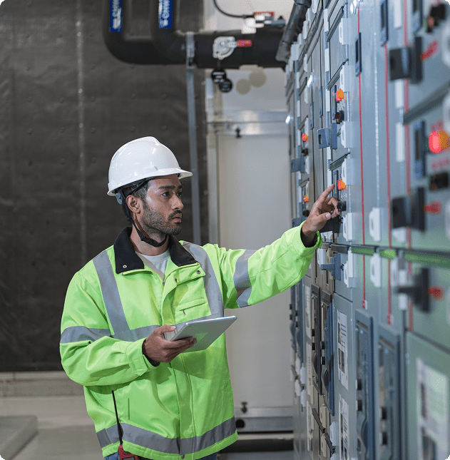 Engineer operating control panel with tablet.