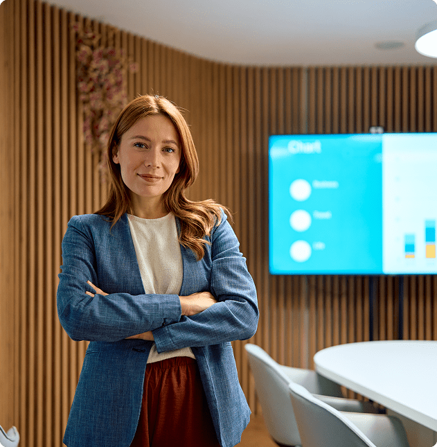 Businesswoman standing confidently in a meeting room.